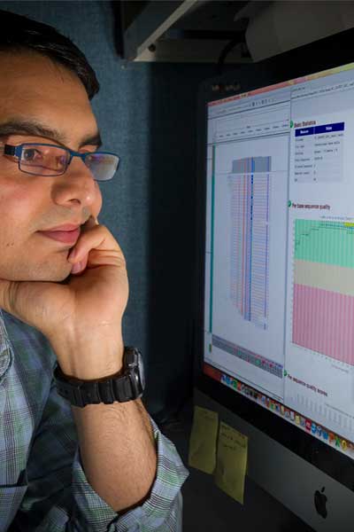 researcher examining data on a computer monitor